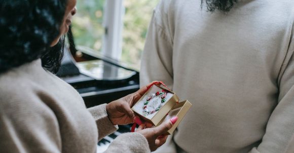 Clothing Exchange - Black woman receiving present from man